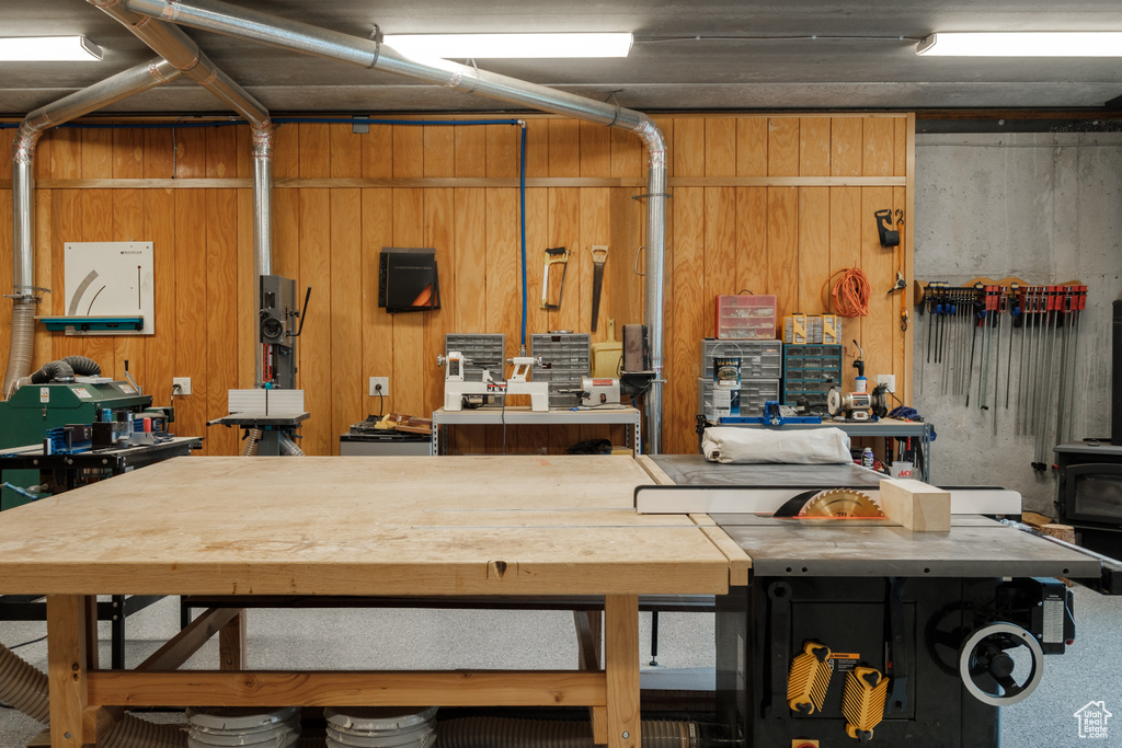 Garage featuring a workshop area and a wood stove