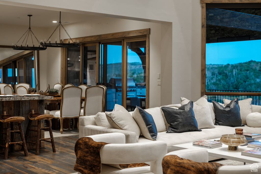 Living room featuring wood finished floors, a chandelier, and recessed lighting