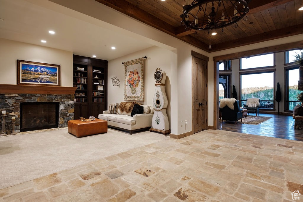 Living room with beamed ceiling, a fireplace, and wooden ceiling