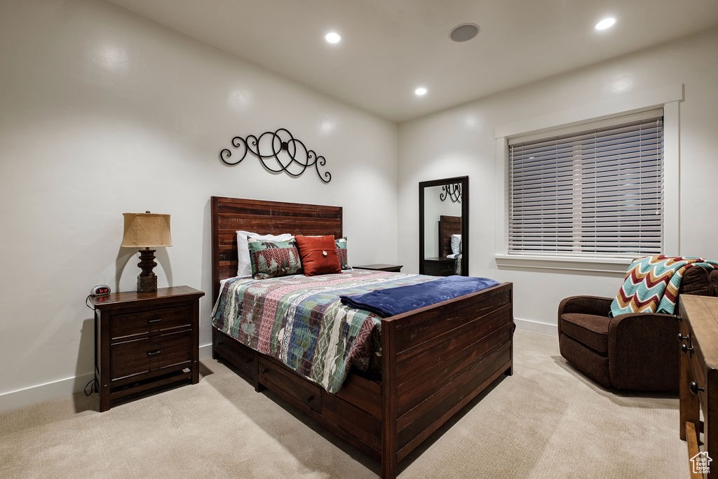 Bedroom featuring light carpet