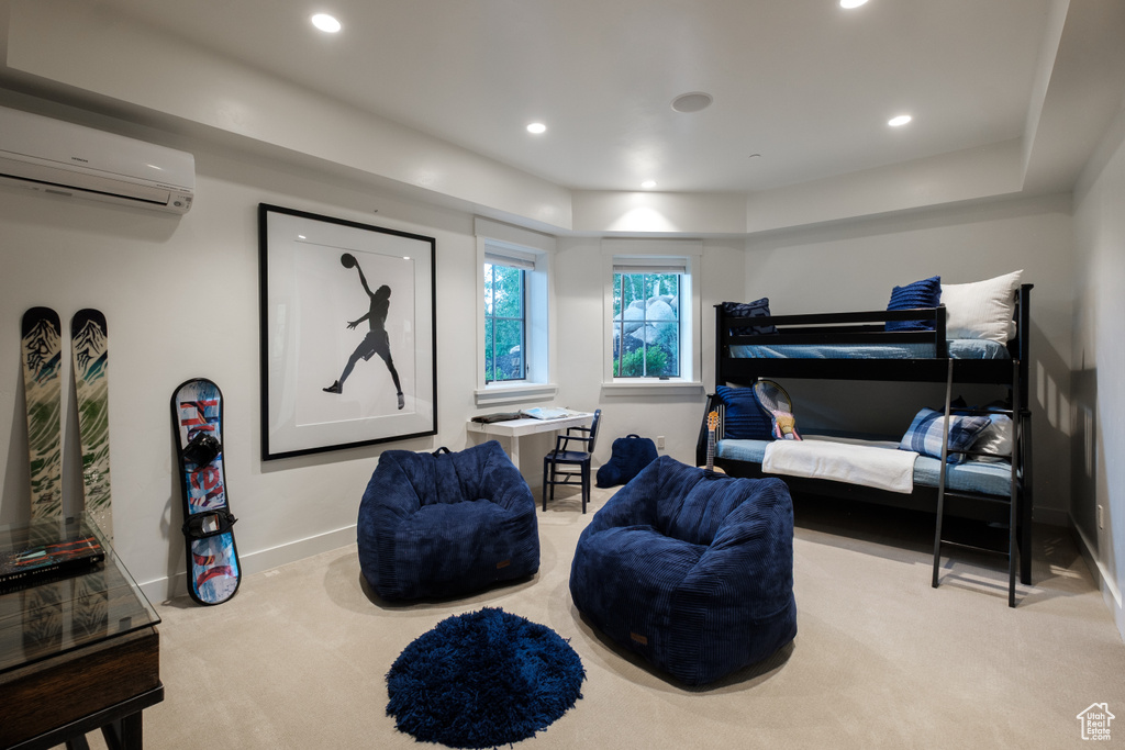Bedroom with carpet, an AC wall unit, and recessed lighting