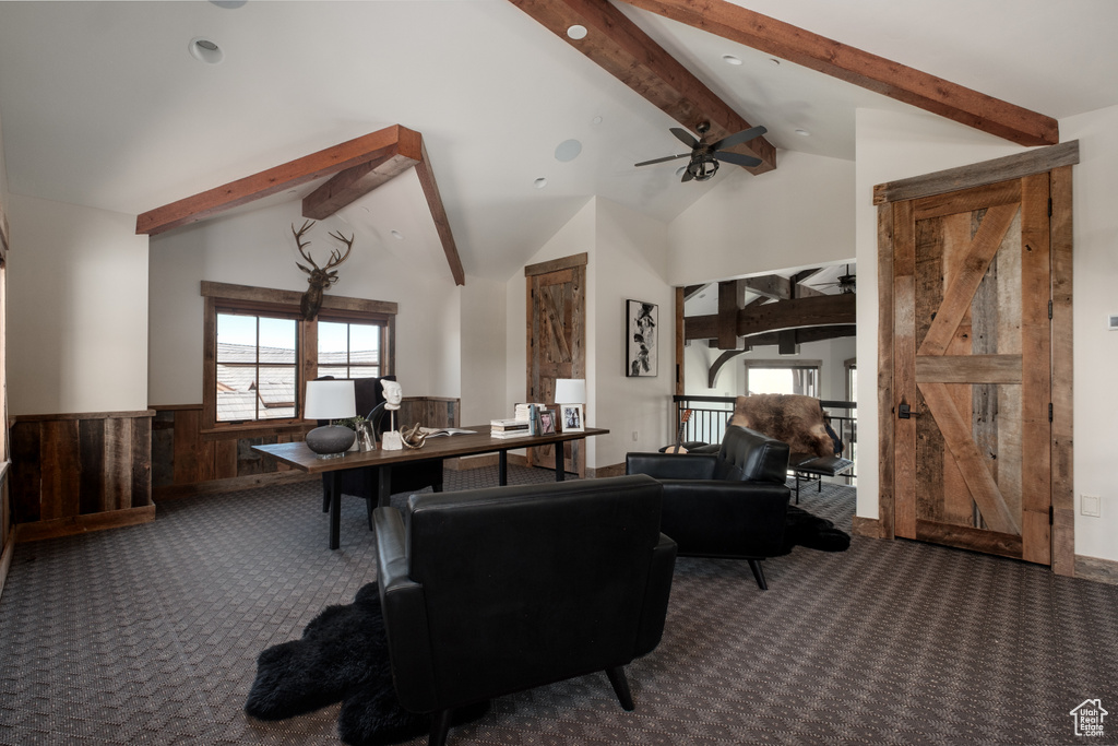 Carpeted living room featuring a wainscoted wall and wooden walls
