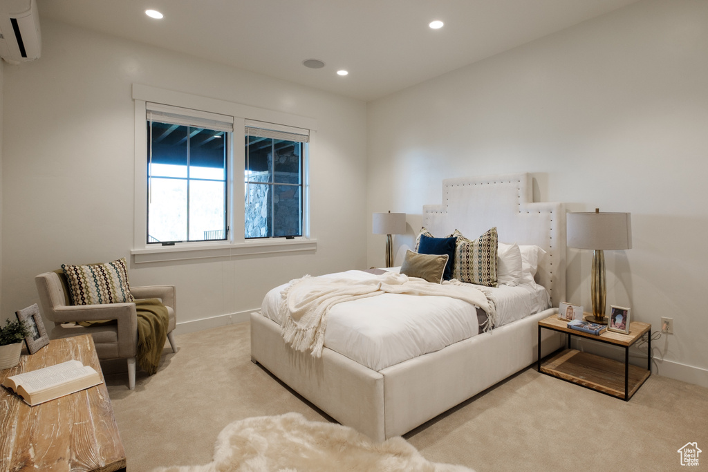 Carpeted bedroom featuring a wall mounted AC and recessed lighting