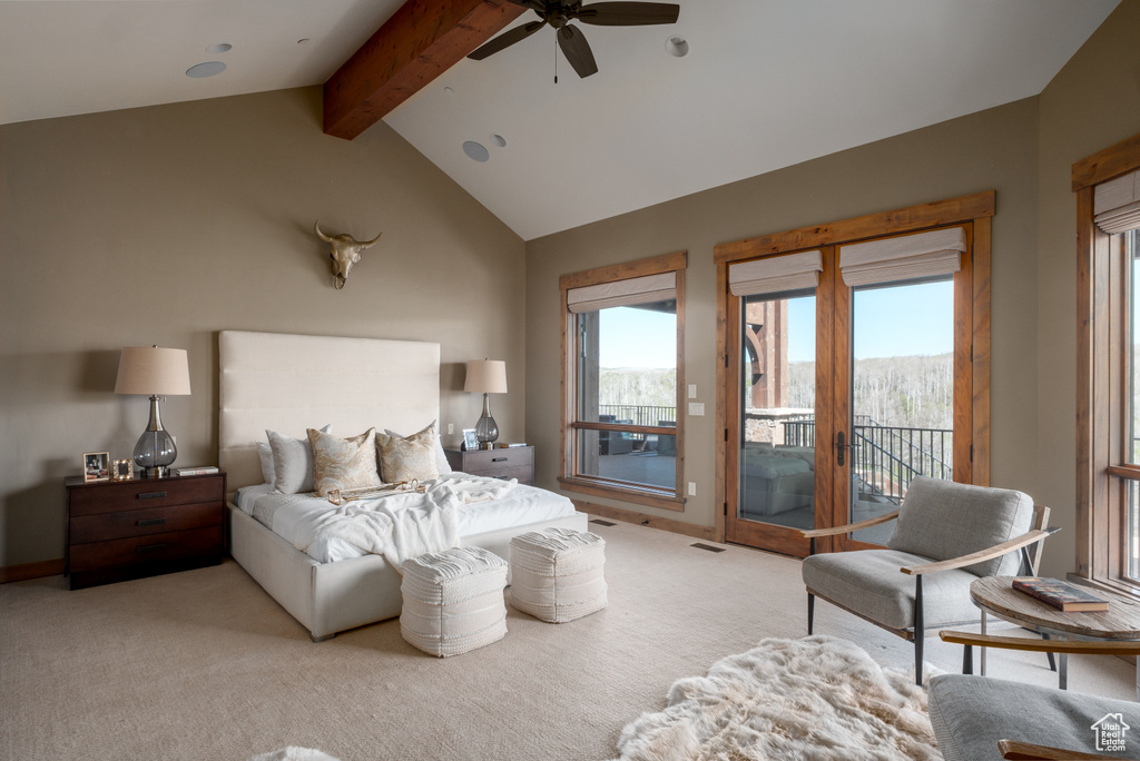 Bedroom featuring access to exterior, light carpet, and multiple windows