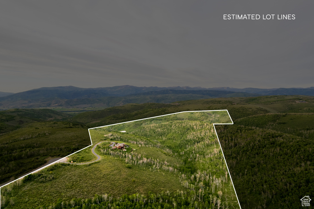 Aerial overview of property\\\'s location featuring a mountainous background and property boundaries highlighted