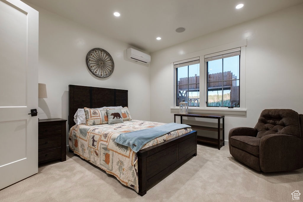 Carpeted bedroom with a wall unit AC