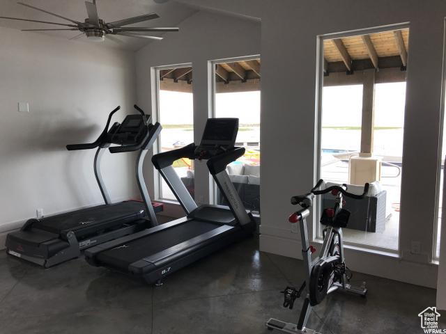 Exercise room with lofted ceiling, ceiling fan, wooden ceiling, and plenty of natural light