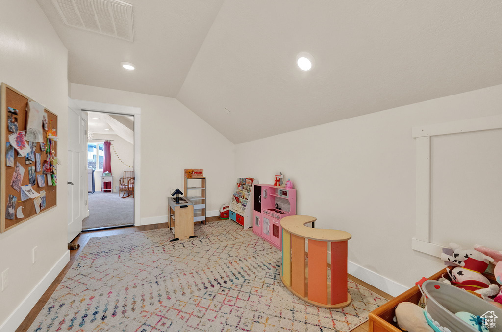 Playroom featuring vaulted ceiling and carpet