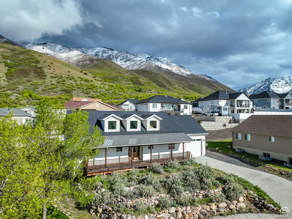 View of front of house with a mountain view and a garage