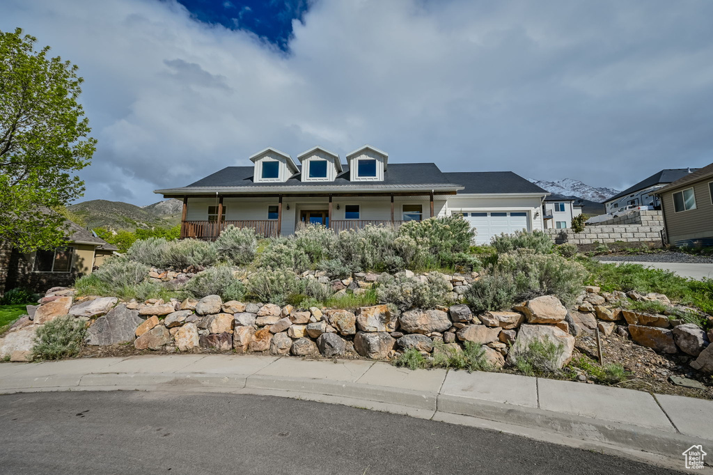 View of front of property featuring a garage and a mountain view