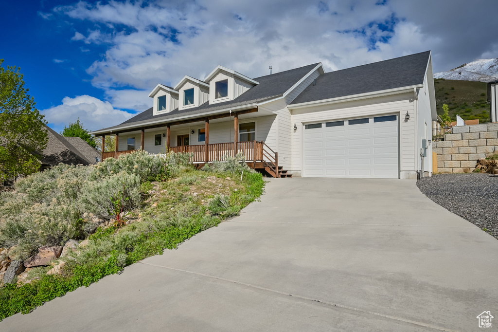 View of front of house featuring covered porch and a garage