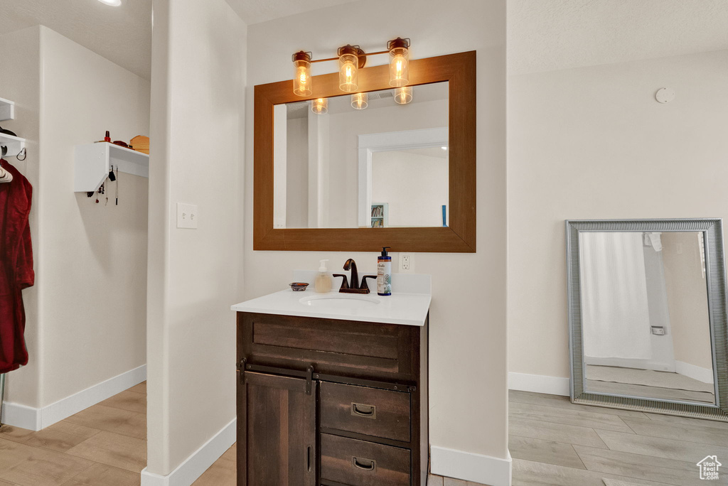 Bathroom featuring vanity and hardwood / wood-style floors