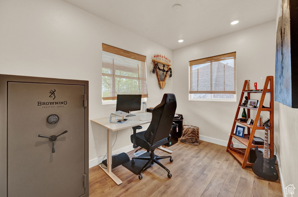 Office with light hardwood / wood-style floors