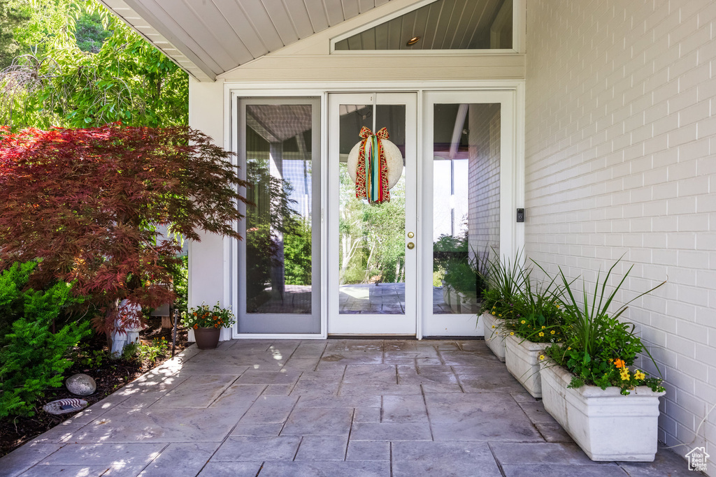 View of exterior entry with french doors and a patio