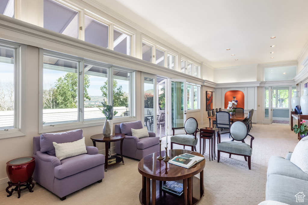 Living room with plenty of natural light, ornamental molding, and carpet floors