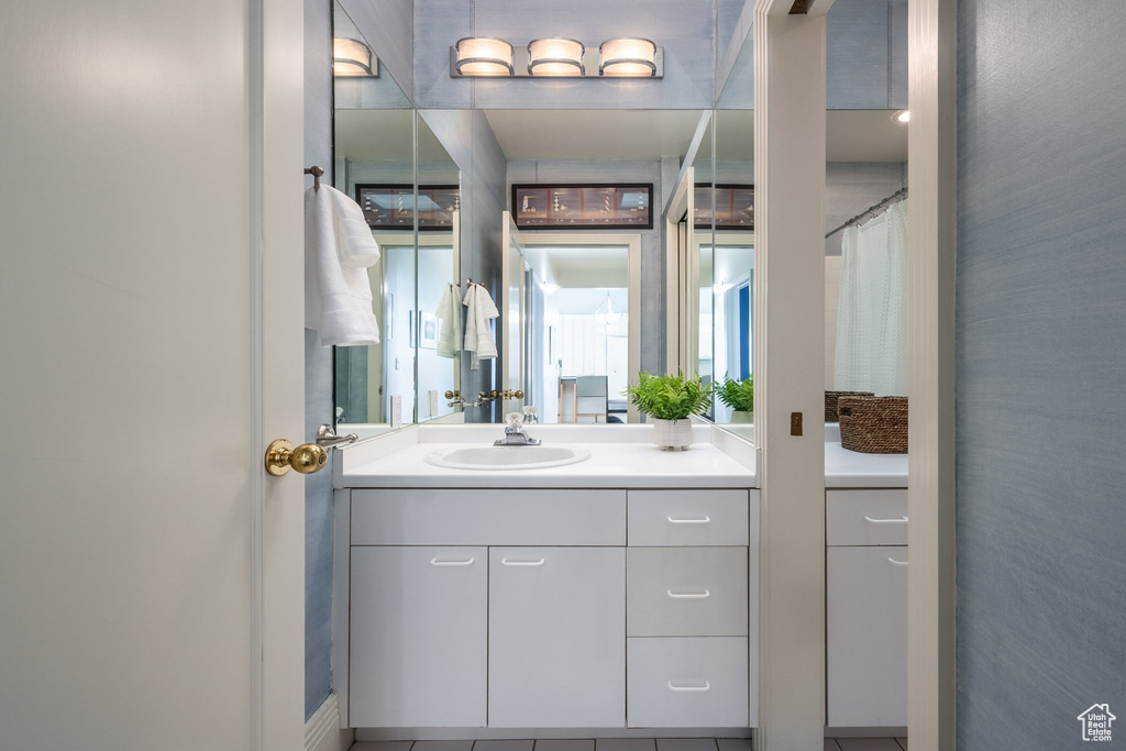 Bathroom featuring tile flooring and vanity