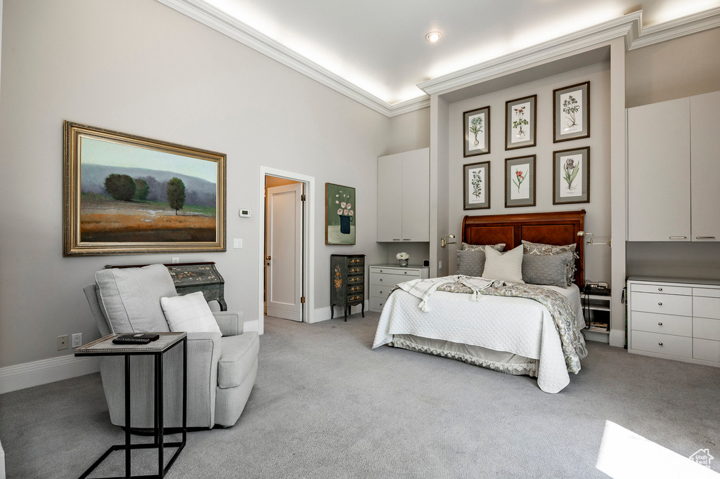 Carpeted bedroom with crown molding