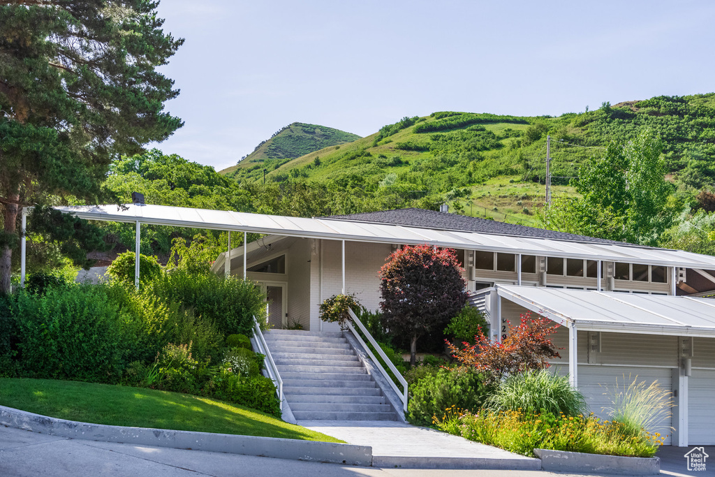 View of front of house with a garage and a mountain view