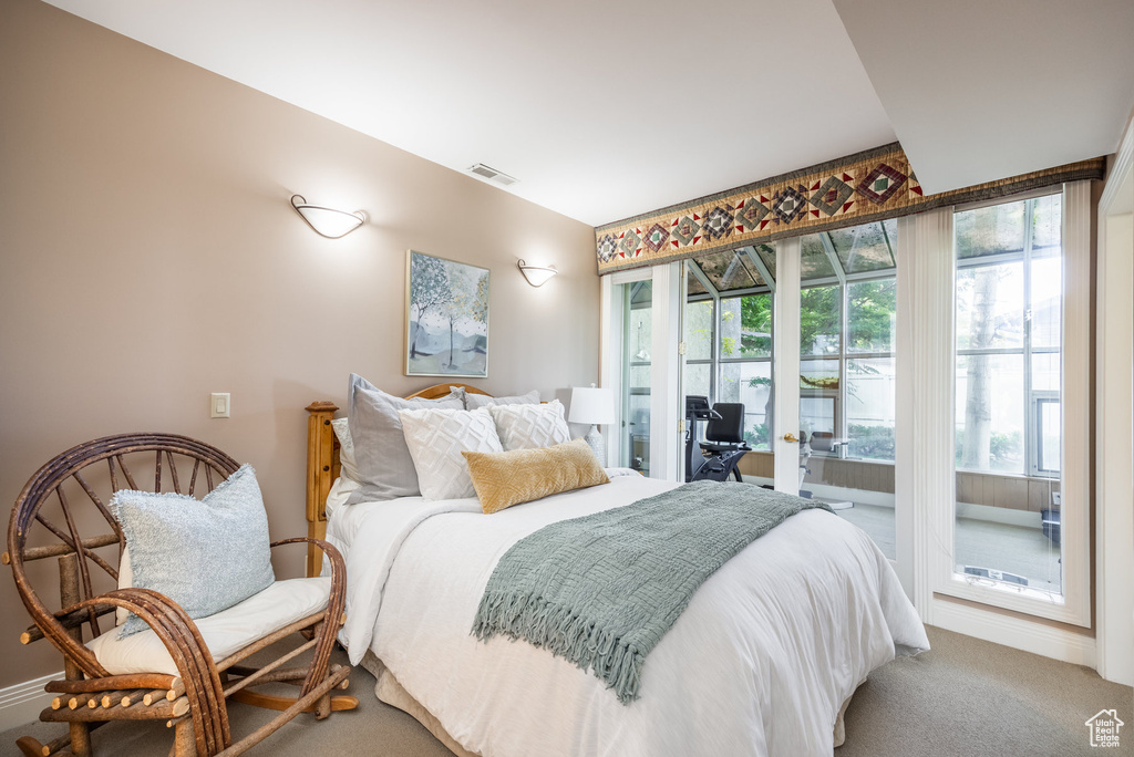 Bedroom featuring access to outside, carpet floors, and multiple windows