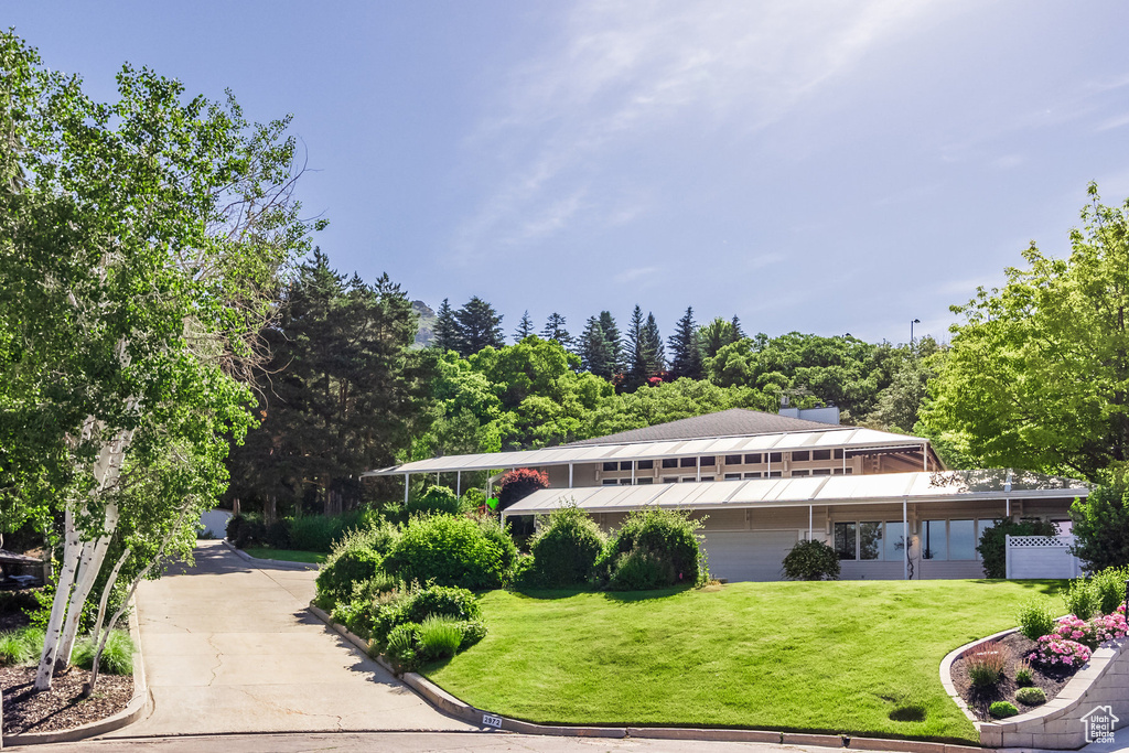 Exterior space featuring a garage and a lawn