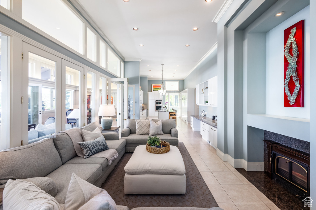 Tiled living room featuring crown molding