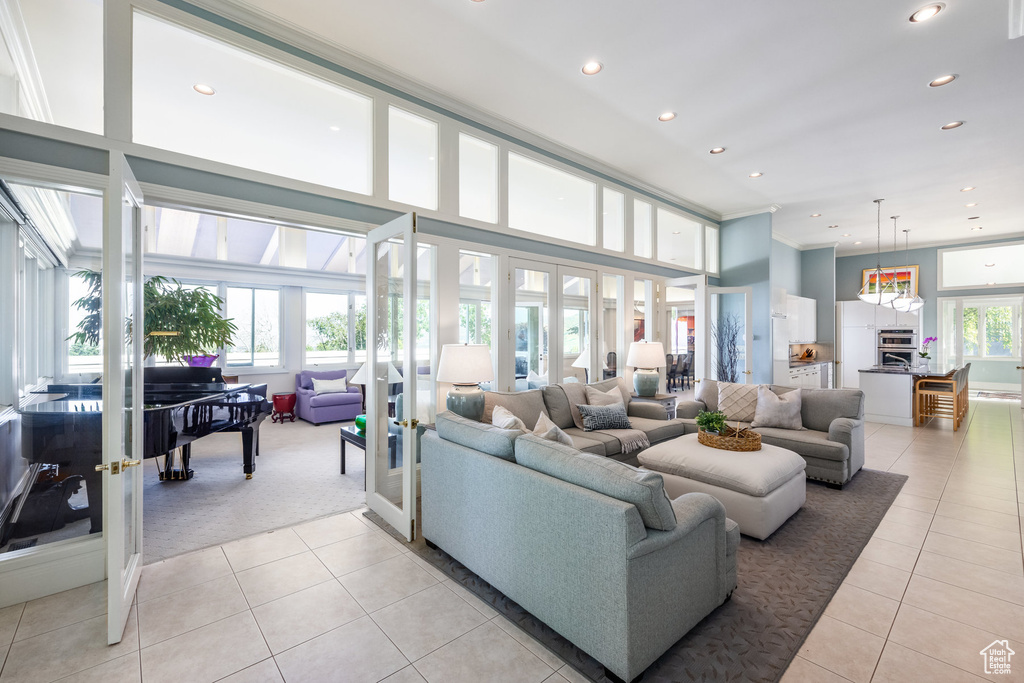 Tiled living room with a high ceiling and french doors