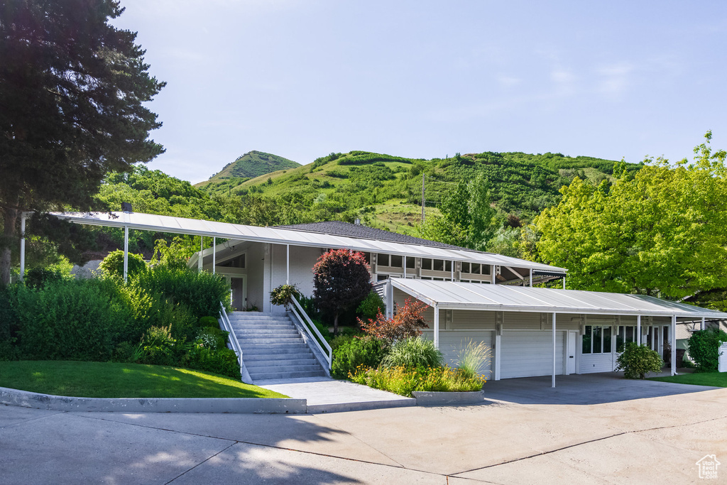 View of front facade with a garage and a mountain view