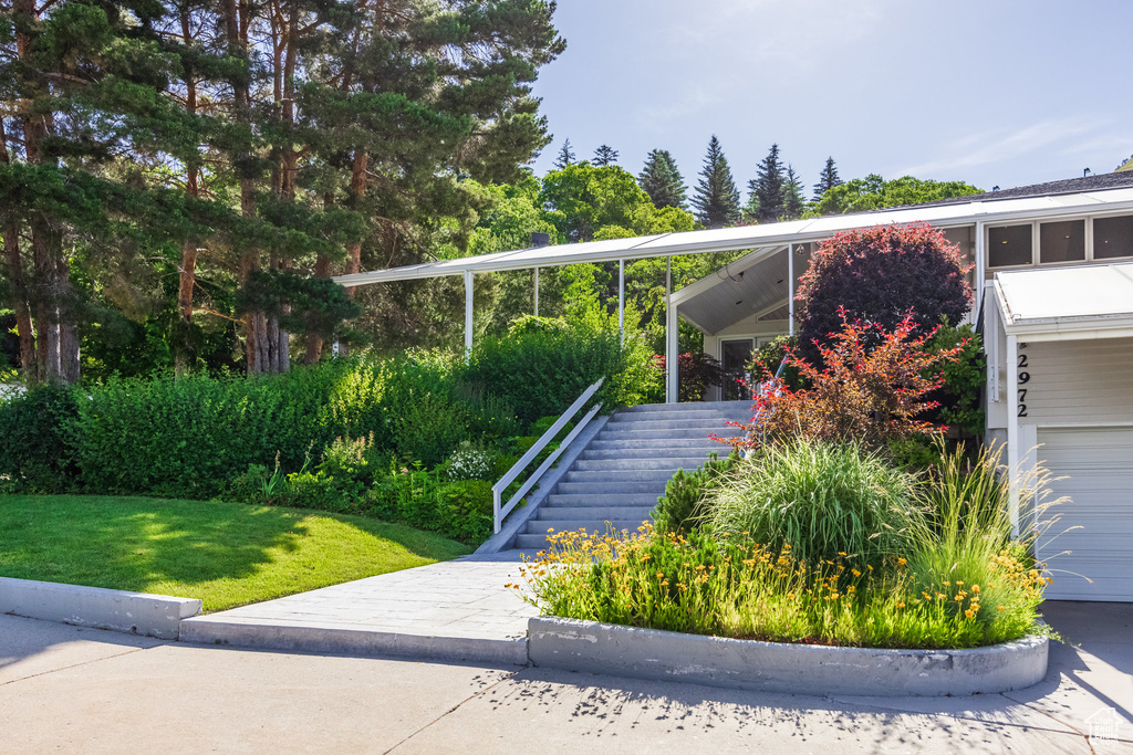 View of front of house featuring a garage and a front lawn