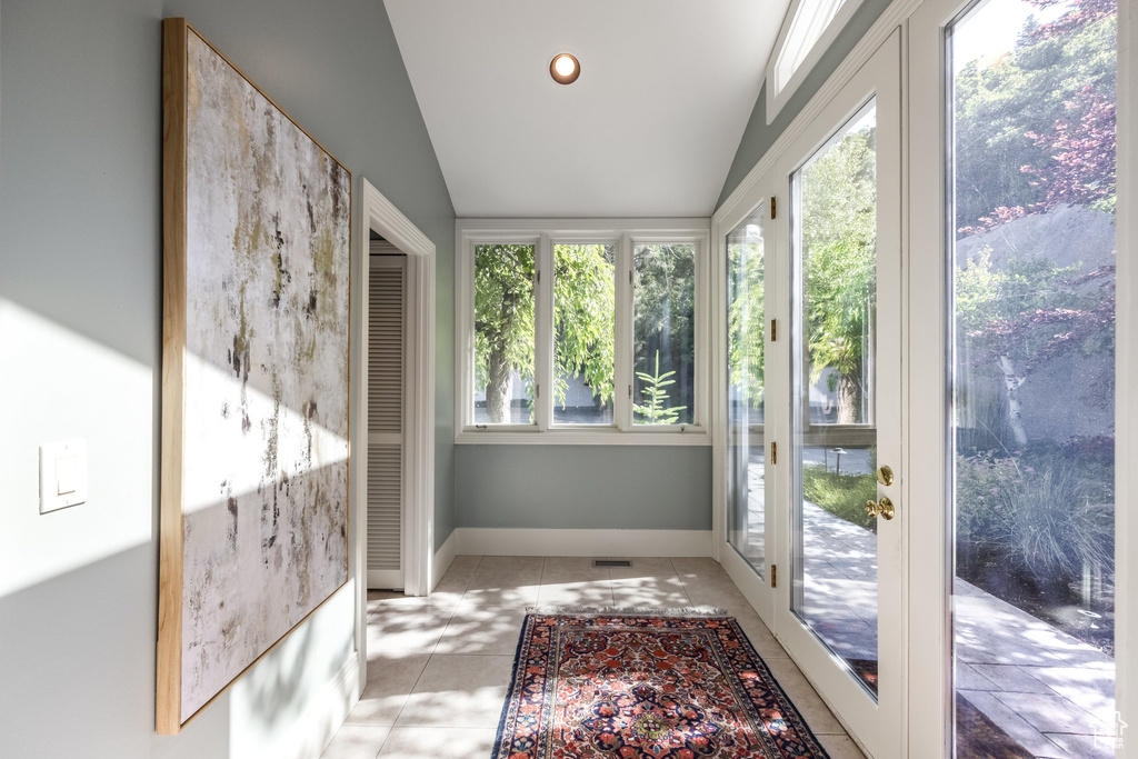 Sunroom featuring lofted ceiling