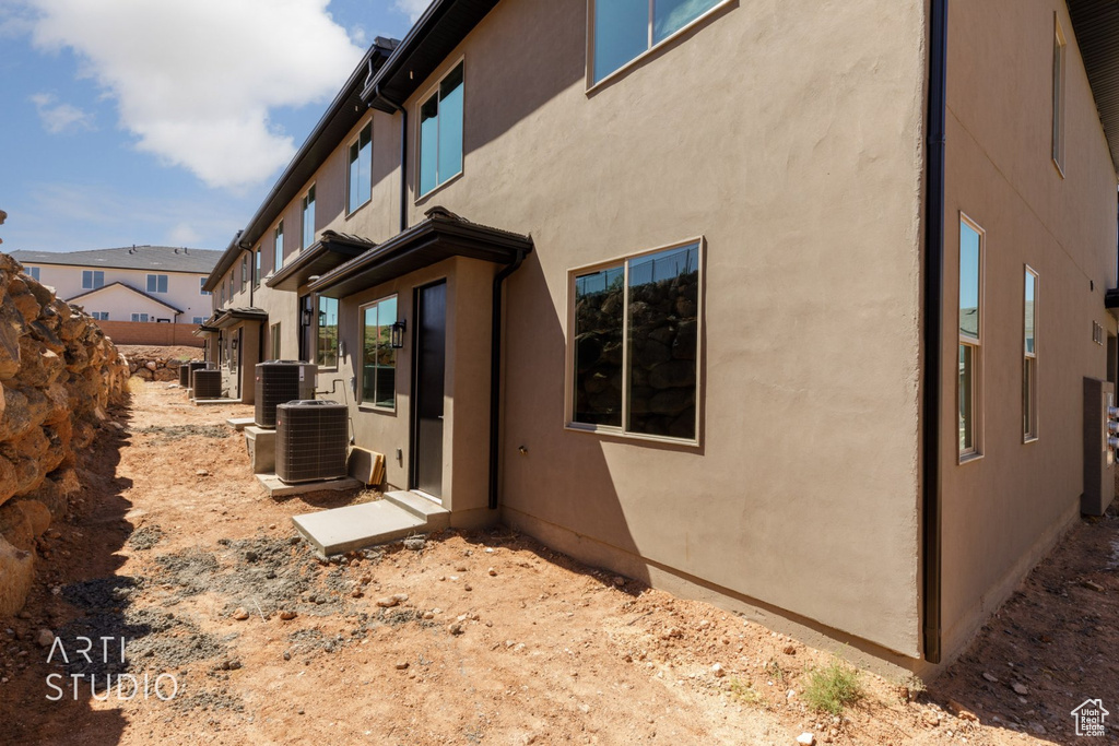 View of side of home with central AC