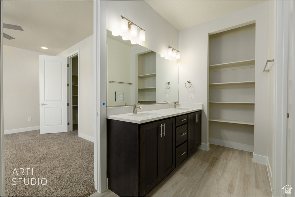 Bathroom featuring wood-type flooring and dual bowl vanity