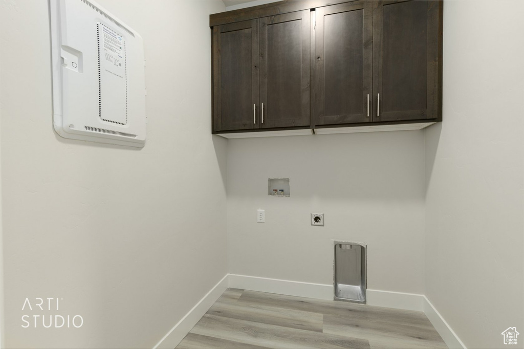 Washroom featuring cabinets, light wood-type flooring, washer hookup, and electric dryer hookup