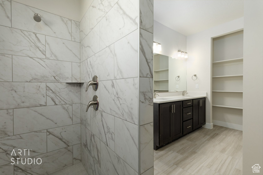 Bathroom with double sink vanity and a tile shower