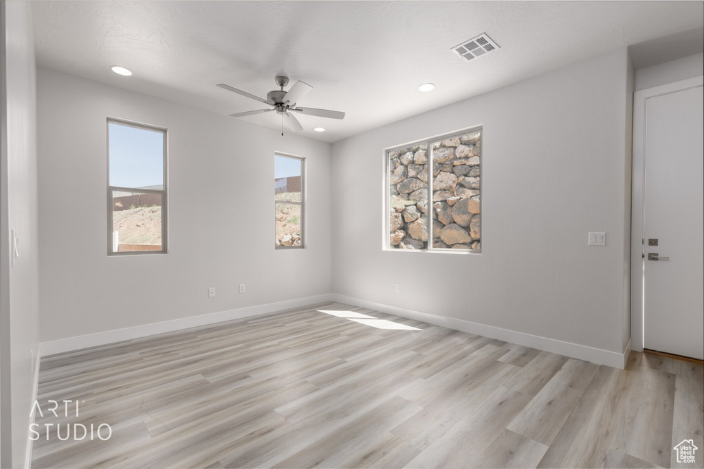 Spare room featuring ceiling fan and light wood-type flooring