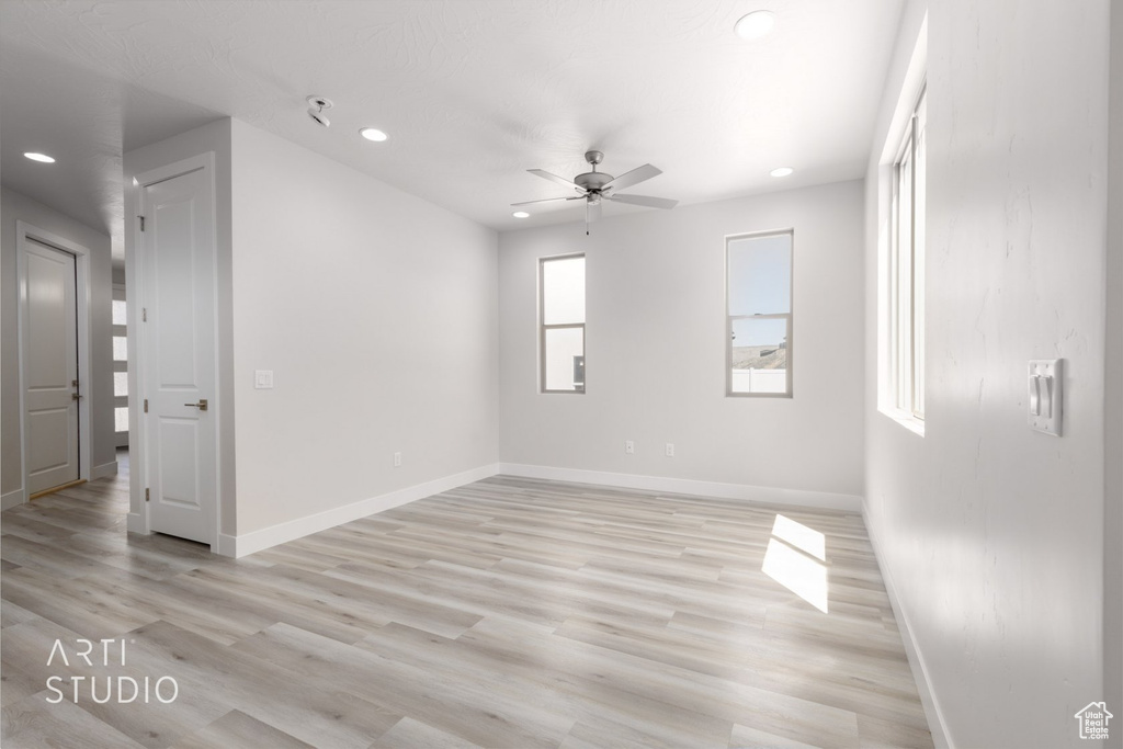 Spare room featuring light hardwood / wood-style floors and ceiling fan