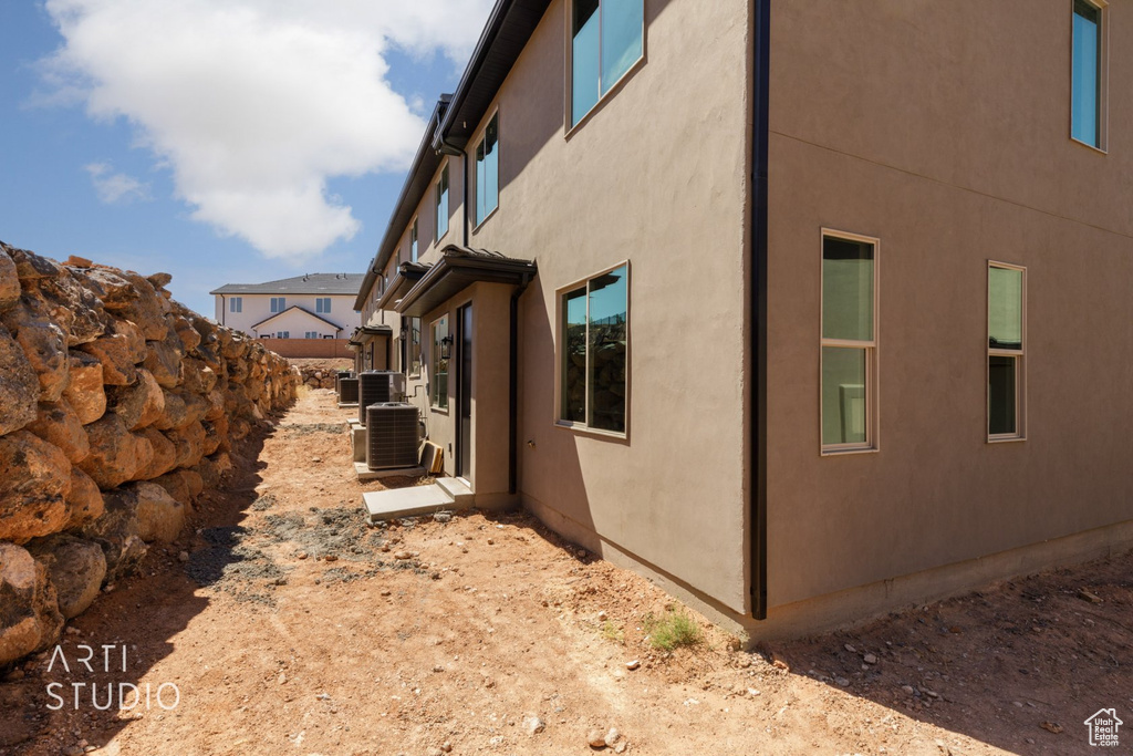 View of side of property with central AC