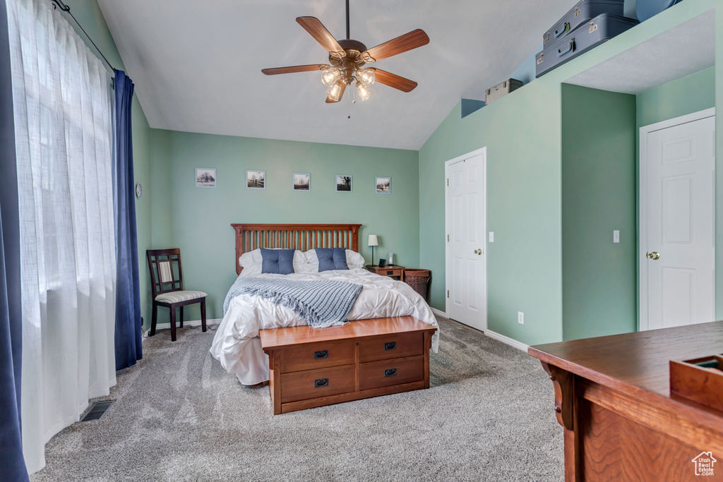 Bedroom with lofted ceiling, carpet floors, and ceiling fan