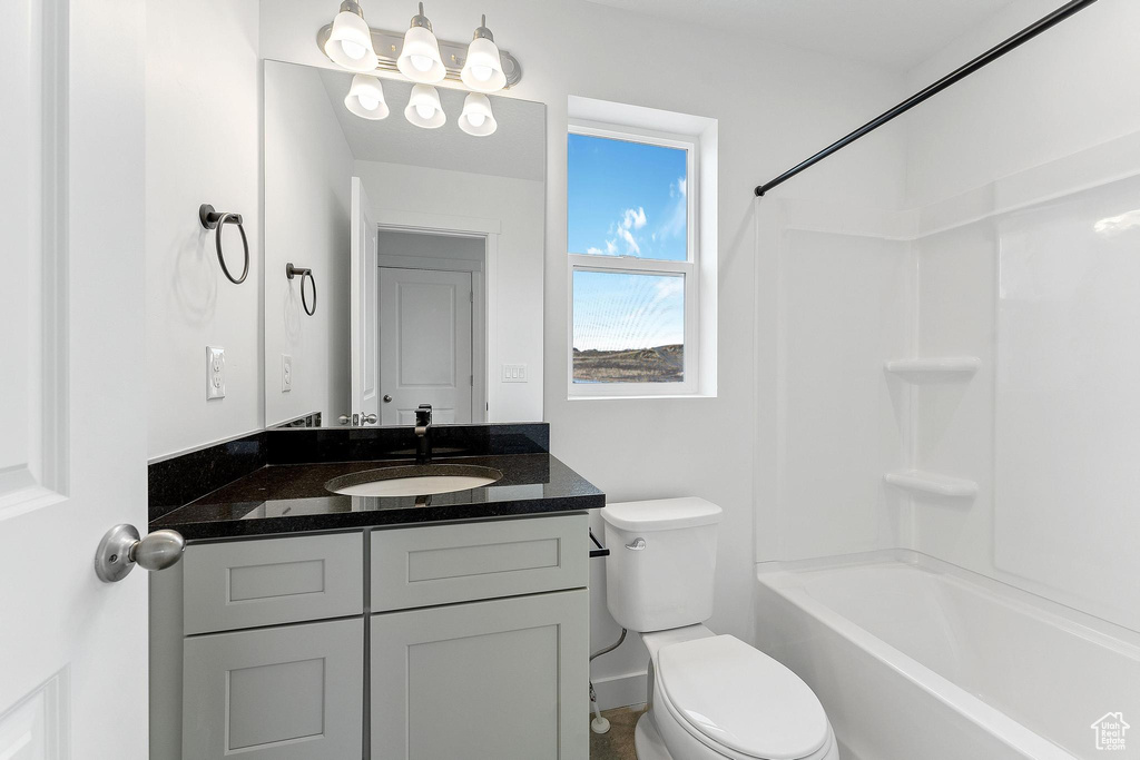 Full bathroom featuring bathtub / shower combination, large vanity, and toilet