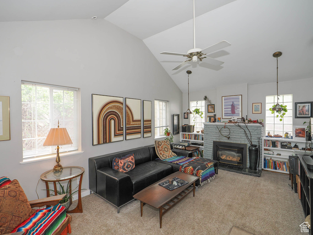 Living room with high vaulted ceiling, ceiling fan, and light carpet