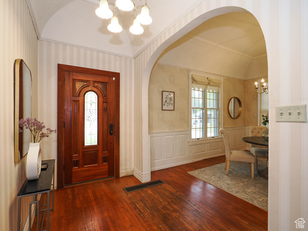 Entryway with a chandelier and dark hardwood / wood-style floors