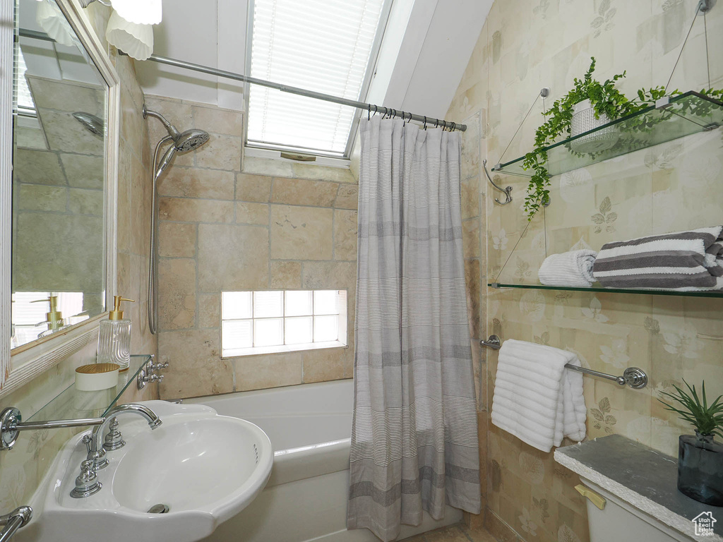 Bathroom featuring sink and shower / bath combo
