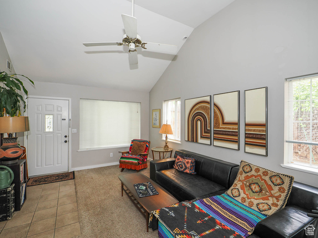 Tiled living room with high vaulted ceiling and ceiling fan