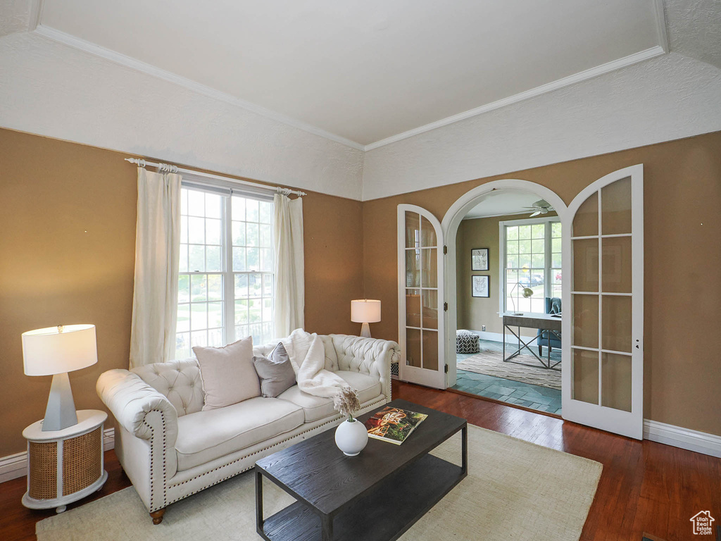 Living room with french doors, ornamental molding, and wood-type flooring