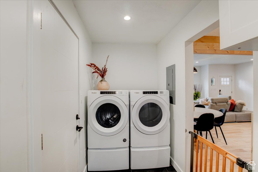 Laundry area with wood-type flooring and washer and dryer