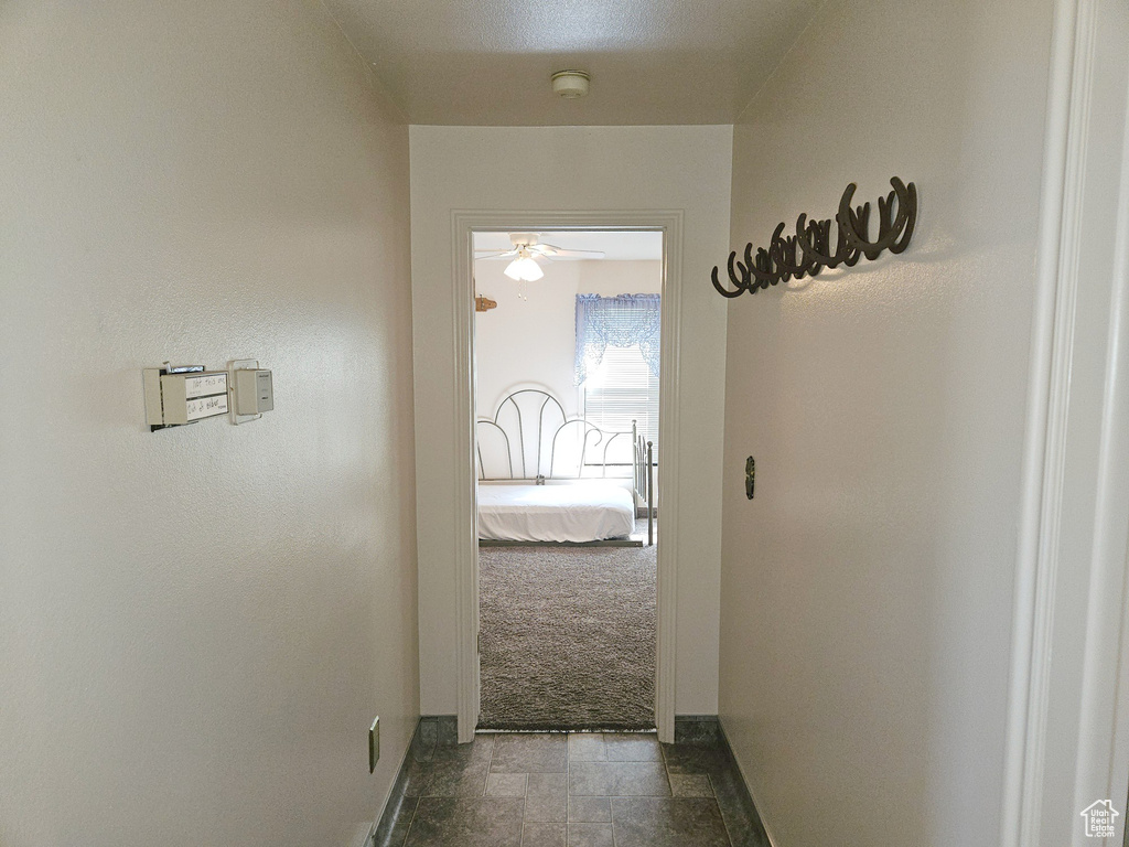 Hallway with tile flooring