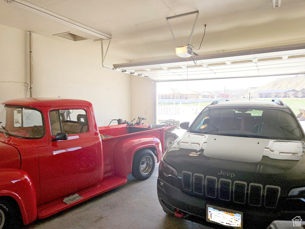 Garage featuring a garage door opener