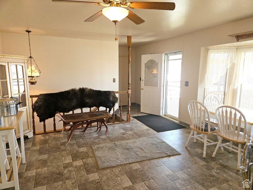 Living room with dark tile flooring and ceiling fan