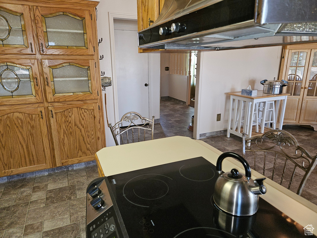 Kitchen with stove and dark tile flooring