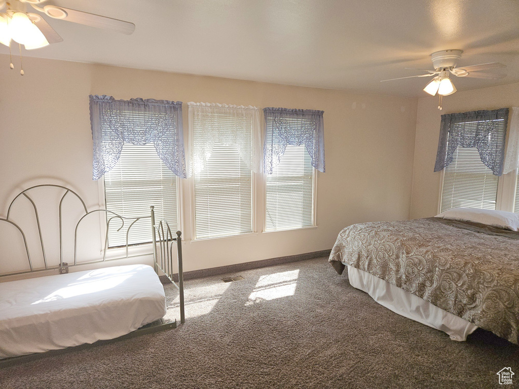 Bedroom with ceiling fan and carpet