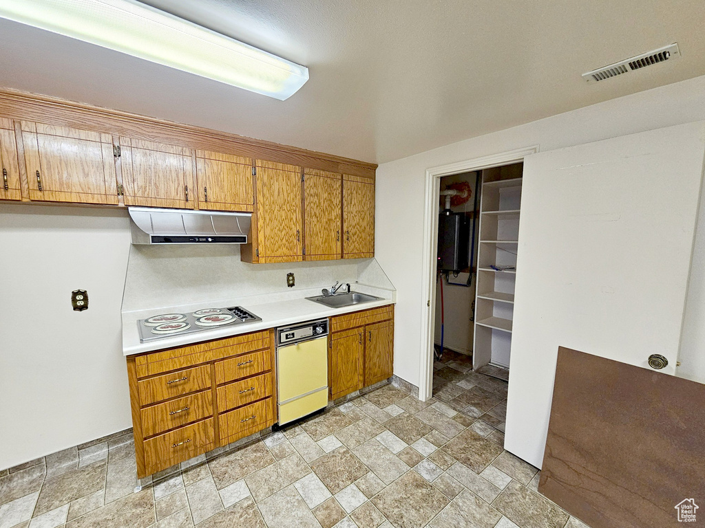 Kitchen with exhaust hood, light tile floors, sink, dishwasher, and gas stovetop